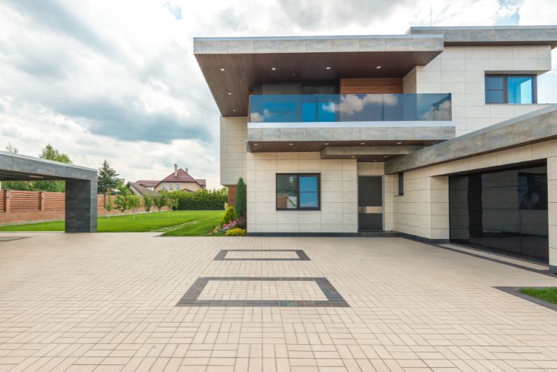 concrete driveway that leads to a garage