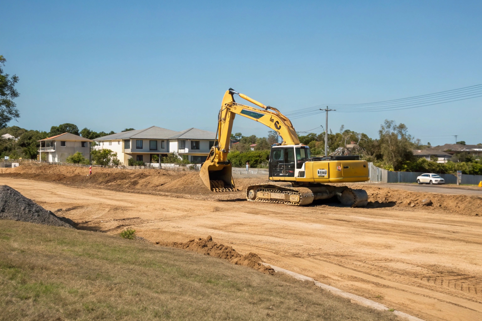 Excavator clearing residential block for site preparation in Hervey Bay