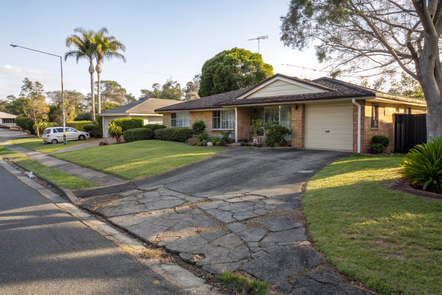 Deteriorating asphalt driveway at Hervey Bay home due for removal and replacement