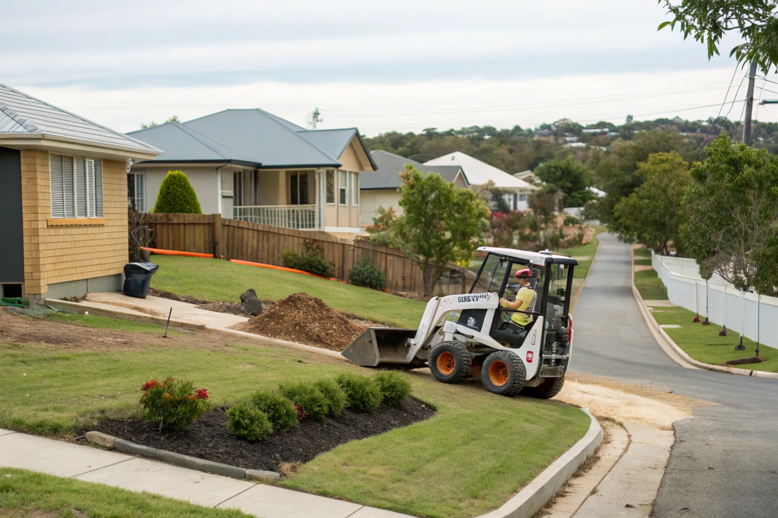 a-skid-steer-loader-working-on-a-confined-resident Skid steer loader completing fine trim site preparation on residential block Fraser Coast