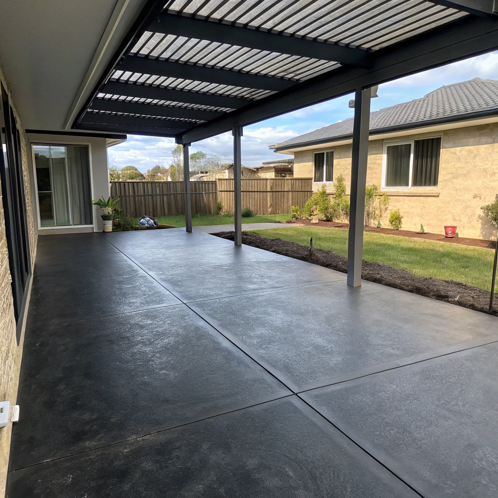 Coloured concrete patio with charcoal finish at a Hervey Bay home